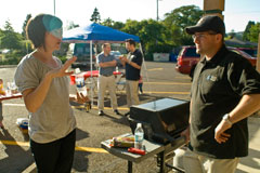 Rebecca Badger and Ryan Gardner from Visual People wait for the hot dogs to grill at Chris Nordyke State Farm's July barbeque