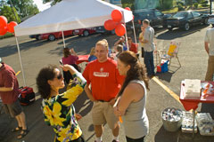 Jason Heckel from Cold Stone Creamery in Corvallis talks with attendees at Chris Nordyke State Farm's July barbeque